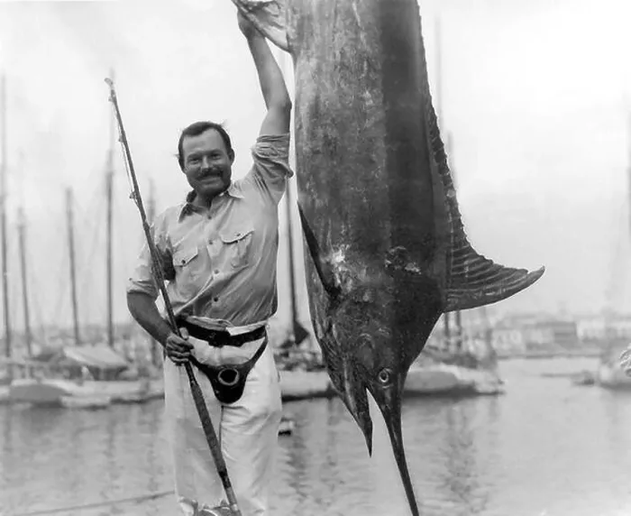 Framed Print : Ernest Hemingway (1899-1961) posing with a marlin at Havana Harbor, Cuba, July, 1934 Framed Print : Ernest Hemingway (1899-1961) posing with a marlin at Havana Harbor, Cuba, July, 1934