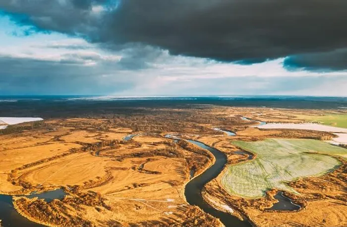 Framed Print : Europe. Aerial View Of Dry Grass And Partly Frozen Curved River Landscape In Autumn Day. High Attitude View. Marsh Bog. Drone View. Bird's Eye View Framed Print : Europe. Aerial View Of Dry Grass And Partly Frozen Curved River Landscape In Autumn Day. High Attitude View. Marsh Bog. Drone View. Bird's Eye View