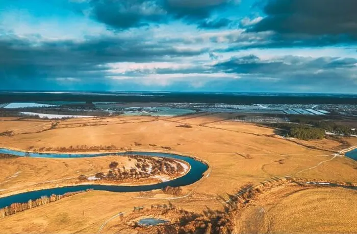 Framed Print : Europe. Aerial View Of Dry Grass And Partly Frozen Curved River Landscape In Autumn Day. High Attitude View. Marsh Bog. Drone View. Bird's Eye View Framed Print : Europe. Aerial View Of Dry Grass And Partly Frozen Curved River Landscape In Autumn Day. High Attitude View. Marsh Bog. Drone View. Bird's Eye View