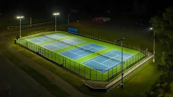 Framed Print : Evening aerial photo of outdoor blue tennis courts with pickleball lines with lights turned on Framed Print : Evening aerial photo of outdoor blue tennis courts with pickleball lines with lights turned on