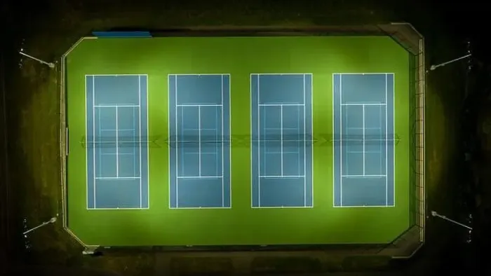 Framed Print : Evening aerial video of outdoor blue tennis courts with pickleball lines with lights turned on Framed Print : Evening aerial video of outdoor blue tennis courts with pickleball lines with lights turned on