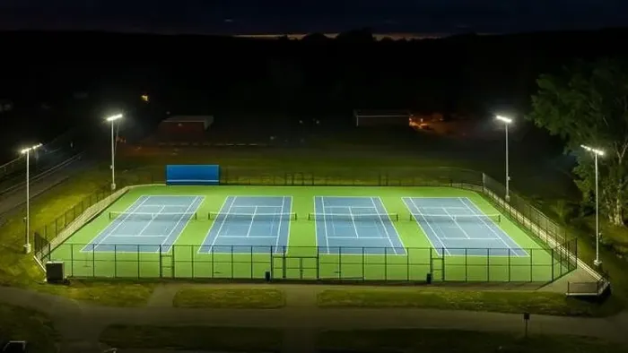Framed Print : Evening aerial video of outdoor blue tennis courts with pickleball lines with lights turned on Framed Print : Evening aerial video of outdoor blue tennis courts with pickleball lines with lights turned on