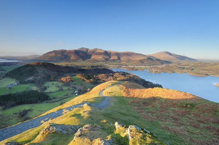 Framed Print : Evening spring sunshine on Skelgill Bank, Cat Bells, Skiddaw and Blencathra in the English Lake District Framed Print : Evening spring sunshine on Skelgill Bank, Cat Bells, Skiddaw and Blencathra in the English Lake District