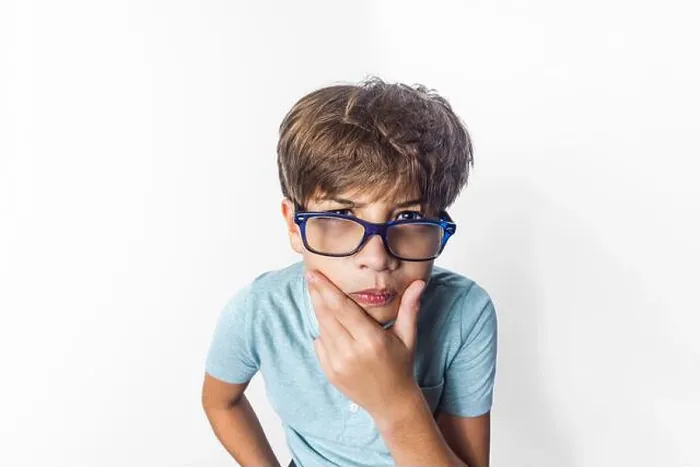 Framed Print : An exaggerated close up portrait of a funny little boy with glasses making a thinking face Framed Print : An exaggerated close up portrait of a funny little boy with glasses making a thinking face