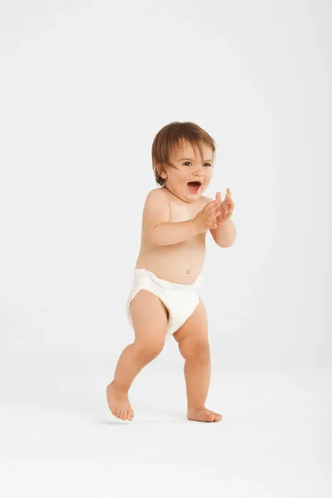 Framed Print : Excited toddler taking first steps in white studio Framed Print : Excited toddler taking first steps in white studio