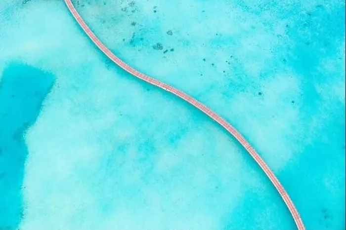 Framed Print : Exotic aerial view of turquoise water with wooden jetty in Maldives islands. Amazing sea lagoon. Tropical ocean water, sunny weather, abstract aerial Framed Print : Exotic aerial view of turquoise water with wooden jetty in Maldives islands. Amazing sea lagoon. Tropical ocean water, sunny weather, abstract aerial