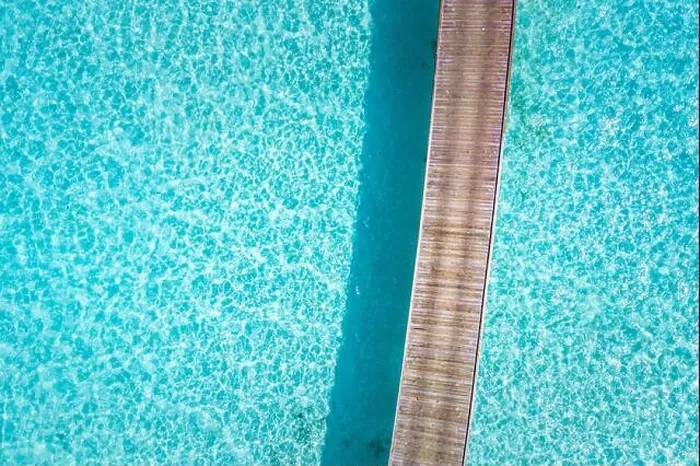 Framed Print : Exotic aerial view of turquoise water with wooden jetty in Maldives islands. Amazing sea lagoon. Tropical ocean water, sunny weather, abstract aerial Framed Print : Exotic aerial view of turquoise water with wooden jetty in Maldives islands. Amazing sea lagoon. Tropical ocean water, sunny weather, abstract aerial