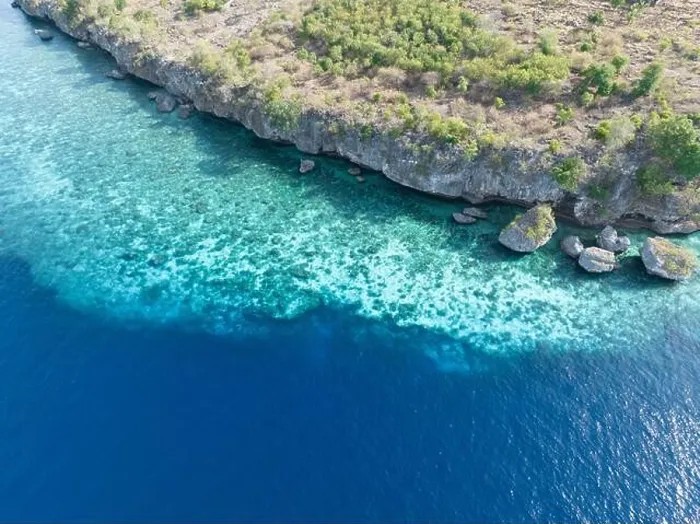 Framed Print : An extensive fringing reef grows along the edge of a remote island near Alor, Indonesia. This region is known for its high marine biodiversity Framed Print : An extensive fringing reef grows along the edge of a remote island near Alor, Indonesia. This region is known for its high marine biodiversity