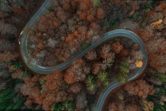 Framed Print : Eycatching drone view at a s-curve in the fall season with light trails of driving cars at the bending road Framed Print : Eycatching drone view at a s-curve in the fall season with light trails of driving cars at the bending road