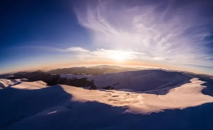 Framed Print : Fabulous evening panorama with snow-capped mountains and hills with bright sun and fog on a frosty winter evening Framed Print : Fabulous evening panorama with snow-capped mountains and hills with bright sun and fog on a frosty winter evening