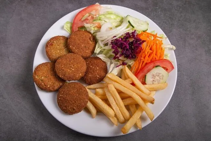 Framed Print : Falafel plate with salad and french fries isolated on rustic background Framed Print : Falafel plate with salad and french fries isolated on rustic background