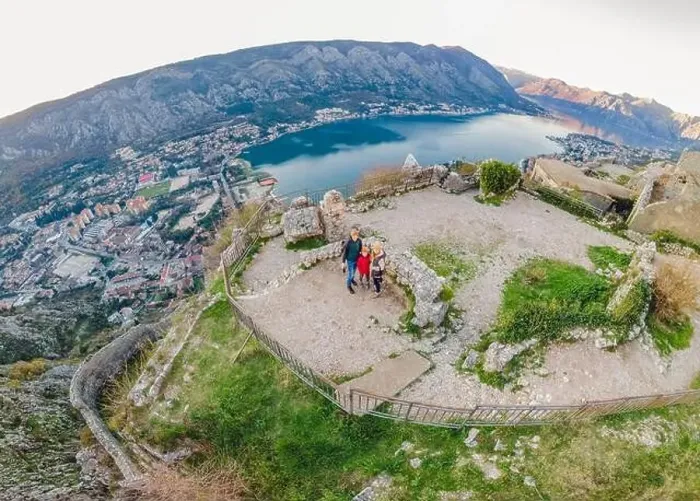 Framed Print : Family of hikers on Hiking in Kotor Old Town Ladder of Kotor Fortress Hiking Trail. Aerial drone view