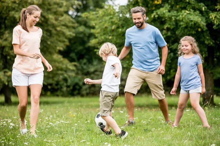 Framed Print : Family and kids play soccer together at garden in summer Framed Print : Family and kids play soccer together at garden in summer
