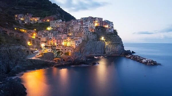 Fantastic landscape of Manarola city with costal rocks on a foreground. Cinque Terre National Park, Liguria, Italy, Europe