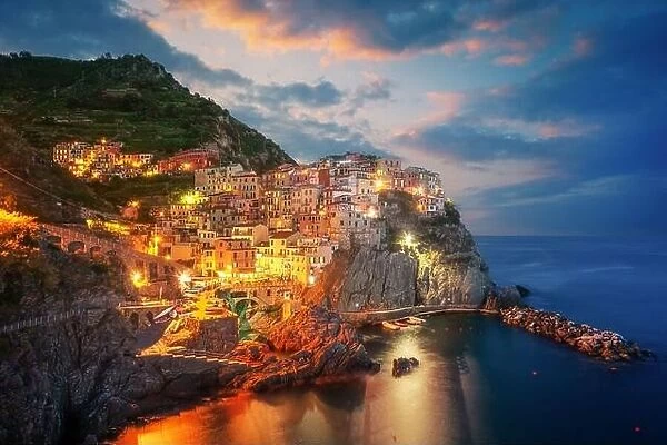 Fantastic morning view of Manarola city with costal rocks on a foreground. Cinque Terre National Park, Liguria, Italy, Europe. Landscape photography