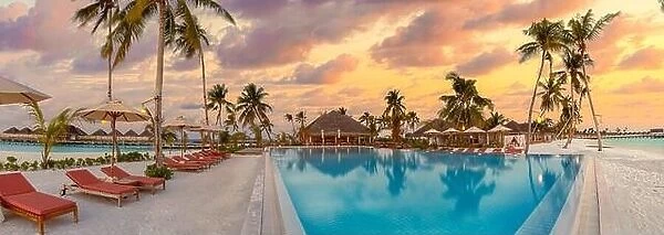 Fantastic panoramic poolside, sunset sky, palm trees. Luxury tropical beach landscape, infinity swimming pool, deck chairs beds under umbrellas