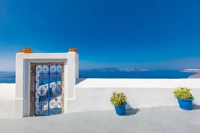 Framed Print : Fantastic travel background, Santorini urban landscape. Red door, gate with stairs white architecture under blue sky. Idyllic summer vacation luxury Framed Print : Fantastic travel background, Santorini urban landscape. Red door, gate with stairs white architecture under blue sky. Idyllic summer vacation luxury