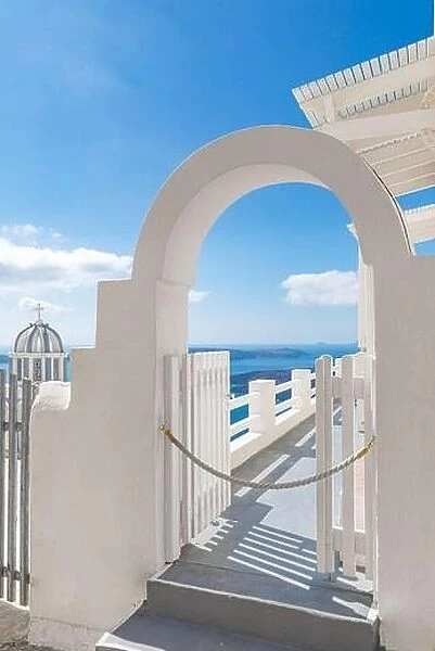 Fantastic vertical panoramic landscape, white architecture and white door entrance into blue sea view. Santorini, Greece, travel destination, vacation