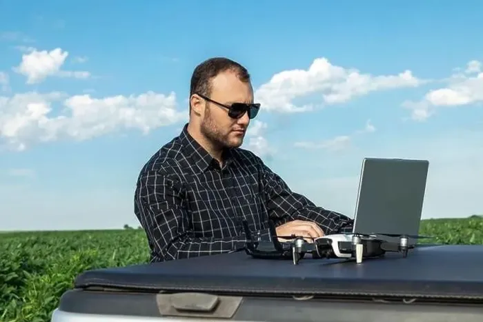 Framed Print : Farmer standing in soybean field looking at notebook and drone Framed Print : Farmer standing in soybean field looking at notebook and drone