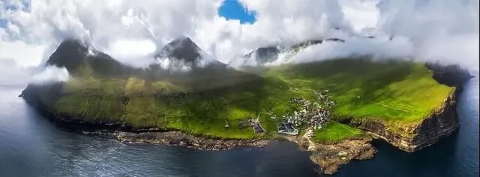 Framed Print : Faroe islands - Aerial panoramic view of the village of gjogv on cliffs washed by the ocean Framed Print : Faroe islands - Aerial panoramic view of the village of gjogv on cliffs washed by the ocean