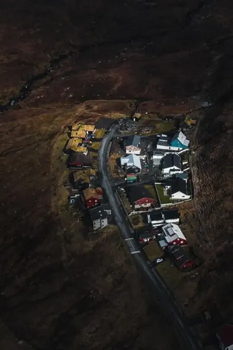 Framed Print : Faroese village as seen from above during a helicopter flight over the moody spring landscape of the Faroe Islands Framed Print : Faroese village as seen from above during a helicopter flight over the moody spring landscape of the Faroe Islands