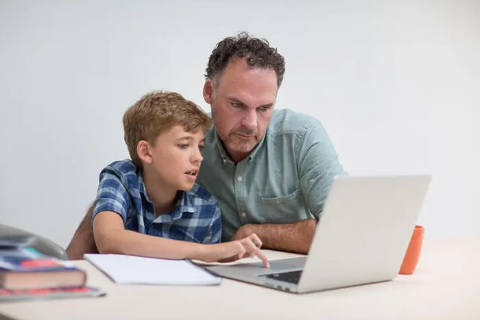 Framed Print : Father helping son with homework Framed Print : Father helping son with homework