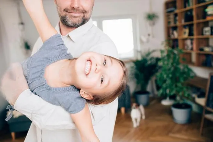 Framed Print : Father playing with daughter, pretending to fly Framed Print : Father playing with daughter, pretending to fly