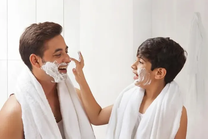 Framed Print : Father and son putting shaving cream on face Framed Print : Father and son putting shaving cream on face