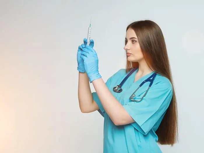 Framed Print : a female doctor holds a syringe in her hand Framed Print : a female doctor holds a syringe in her hand