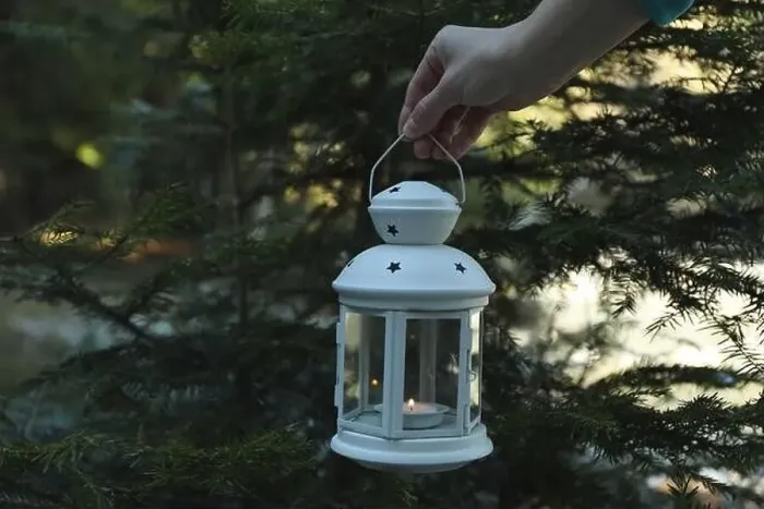Framed Print : Female hand holds lantern with candle in forest Framed Print : Female hand holds lantern with candle in forest