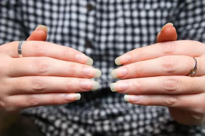 Framed Print : Female Hands. Closeup woman shows her natural nails without nail polish Framed Print : Female Hands. Closeup woman shows her natural nails without nail polish