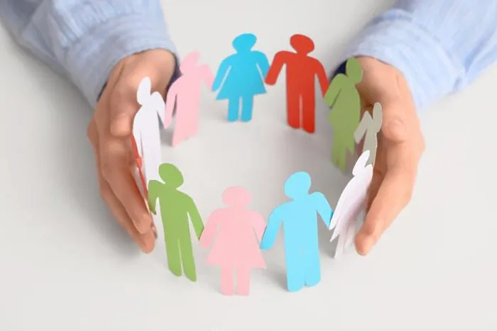 Framed Print : Female hands with colorful paper human figures on light background, closeup. Diversity and inclusion concept Framed Print : Female hands with colorful paper human figures on light background, closeup. Diversity and inclusion concept