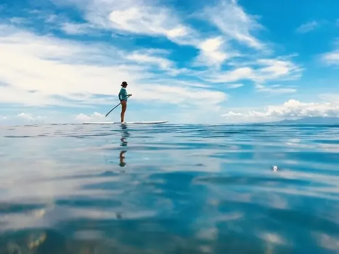 Framed Print : A female stand up paddling. Tavarua Fiji