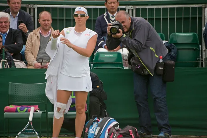 Framed Print : Female Tennis player wearing sunglasses at Wimbledon as photographer takes he photograph from behind as she takes off Framed Print : Female Tennis player wearing sunglasses at Wimbledon as photographer takes he photograph from behind as she takes off