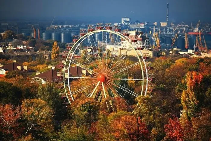 Framed Print : Ferris wheel and roofs of houses in the autumn park from a bird's eye view Framed Print : Ferris wheel and roofs of houses in the autumn park from a bird's eye view