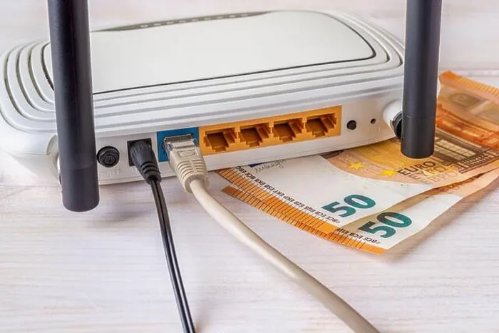 Framed Print : Two fifty euro bill banknotes and white Wi-Fi wireless router with connected cables on a white wooden desk Framed Print : Two fifty euro bill banknotes and white Wi-Fi wireless router with connected cables on a white wooden desk