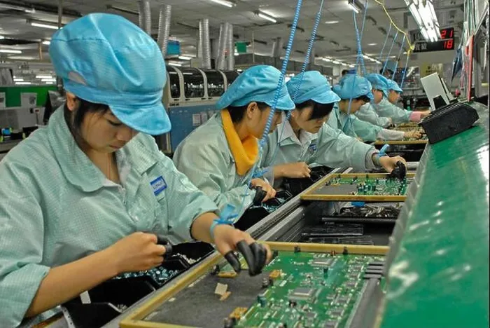 Framed Print : FILE--Chinese migrant workers labor at an electronics factory in Dongguan city Framed Print : FILE--Chinese migrant workers labor at an electronics factory in Dongguan city