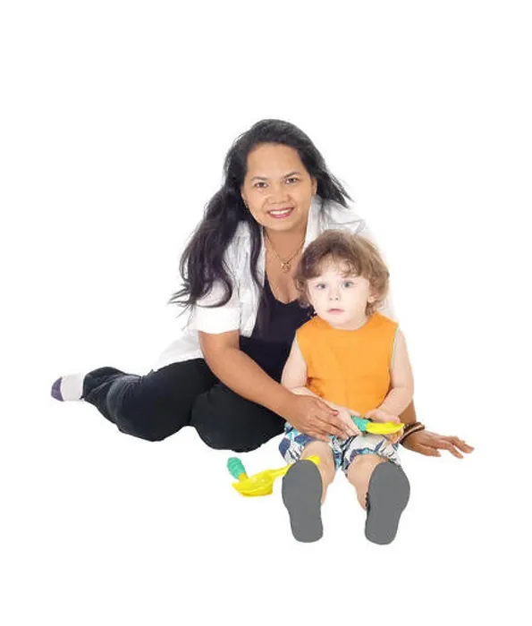 Framed Print : A Filipino nanny sitting on the floor playing with a little three year old boy, isolated for white background Framed Print : A Filipino nanny sitting on the floor playing with a little three year old boy, isolated for white background