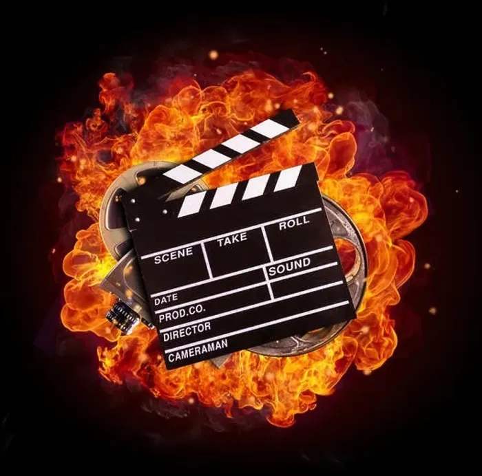 Framed Print : Film clapper, reel and camera in fire, isolated on black background. Concept of filmmaking Framed Print : Film clapper, reel and camera in fire, isolated on black background. Concept of filmmaking