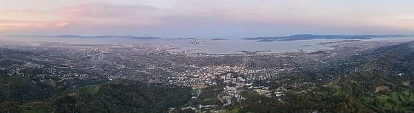 The first light of day shines on San Francisco Bay and the surrounding urban setting in Northern California. Almost 8 million people live here