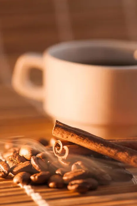 Framed Print : flat angled view of a white Cup on bamboo mat with previous coffee beans and cinnamon on it Framed Print : flat angled view of a white Cup on bamboo mat with previous coffee beans and cinnamon on it