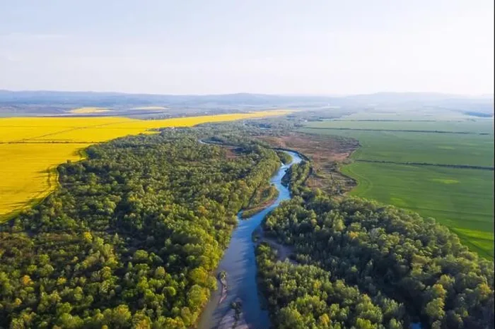 Framed Print : Flight through majestic river Dnister, lush green forest and blooming yellow rapeseed fields at sunset time. Ukraine, Europe. Landscape photography Framed Print : Flight through majestic river Dnister, lush green forest and blooming yellow rapeseed fields at sunset time. Ukraine, Europe. Landscape photography