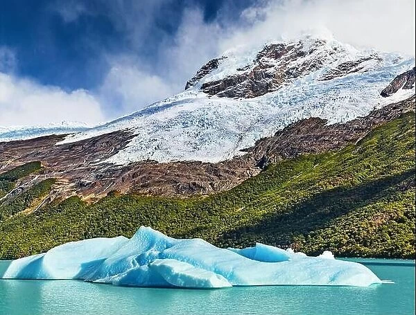 Floating ice floe and snowy mountains. Lake Argentino, the biggest freshwater glacial lake in Argentina, Patagonia, Argentina