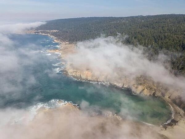 Fog begins to drift over the scenic northern California coastline in Sonoma