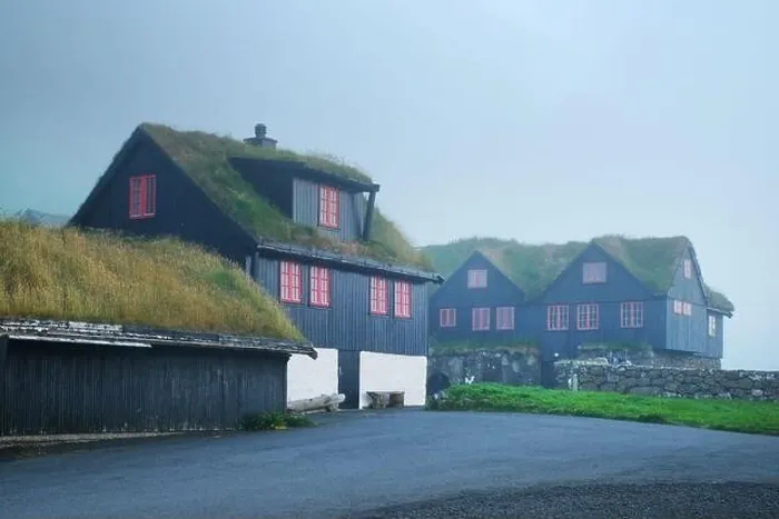 Framed Print : Foggy morning view of a house with typical grass roof