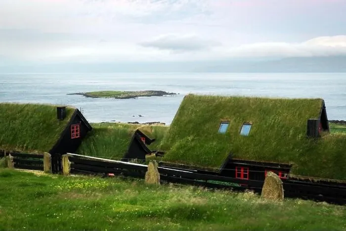 Framed Print : Foggy morning view of a house with typical turf-top grass roof and blue cloudy sky in the Velbastadur village on Streymoy island, Faroe islands Framed Print : Foggy morning view of a house with typical turf-top grass roof and blue cloudy sky in the Velbastadur village on Streymoy island, Faroe islands