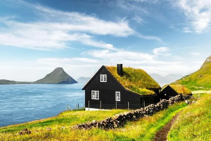 Framed Print : Foggy morning view of a house with typical turf-top grass roof in the Velbastadur village on Streymoy island, Faroe islands, Denmark Framed Print : Foggy morning view of a house with typical turf-top grass roof in the Velbastadur village on Streymoy island, Faroe islands, Denmark