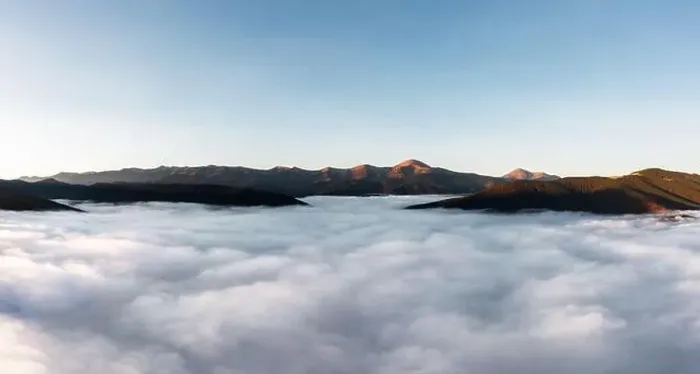Framed Print : Foggy mountain landscape above the clouds at sunset. Aerial view. Mountain peaks stick out from the clouds Framed Print : Foggy mountain landscape above the clouds at sunset. Aerial view. Mountain peaks stick out from the clouds