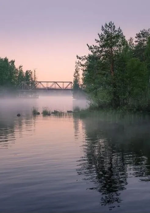 Framed Print : Foggy summer landscape and old iron bridge with beautiful calm lake at summer night in Finland