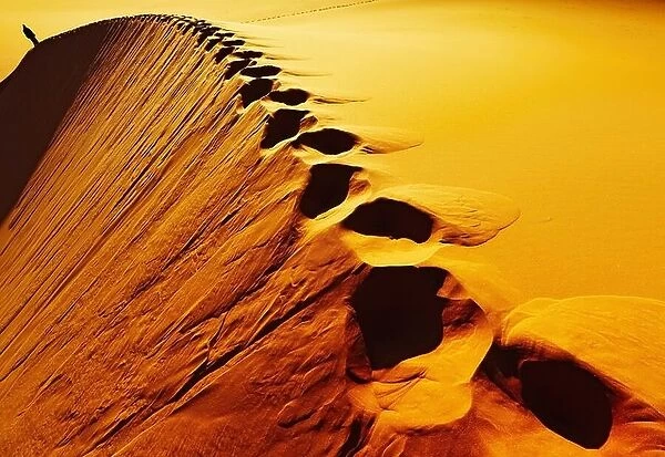 Footprints on sand dune, Sahara Desert, Algeria